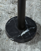 Marble-look black round base with central black pole for a gold floor lamp
