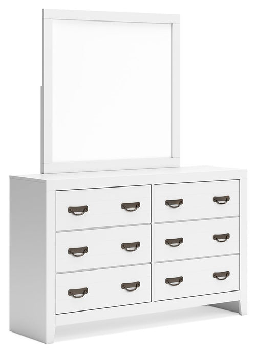 White dresser with attached rectangular mirror and six drawers with bronze handles