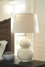 Ceramic table lamp with cream two-piece base and white fabric drum shade