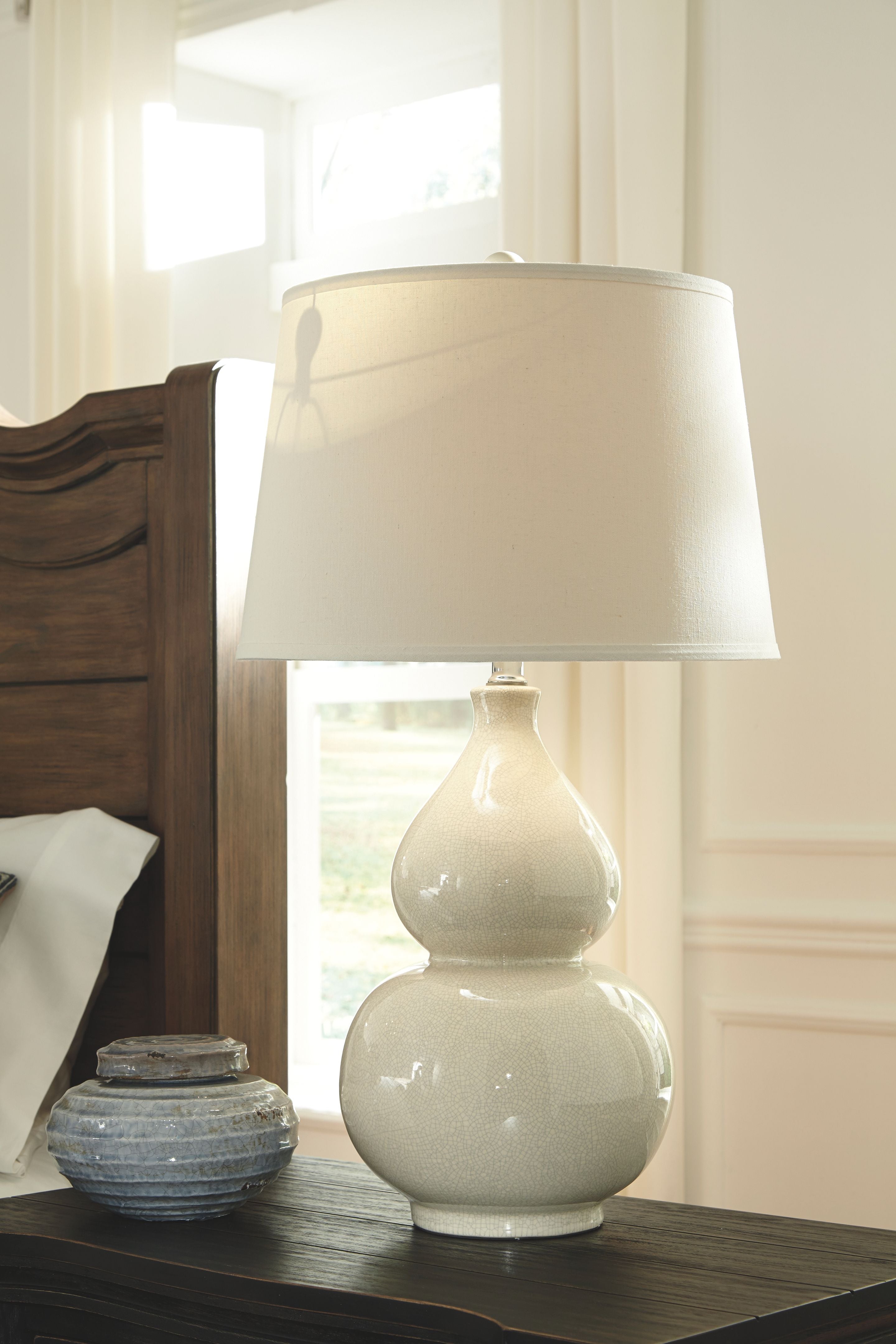 Ceramic table lamp with cream two-piece base and white fabric drum shade