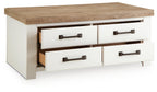 White rectangular table with wood top and two drawers, bronze bar pulls, open center.