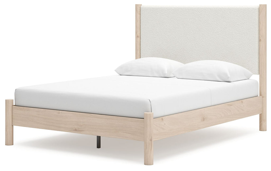Beige upholstered panel bed with light wood frame and upholstered headboard