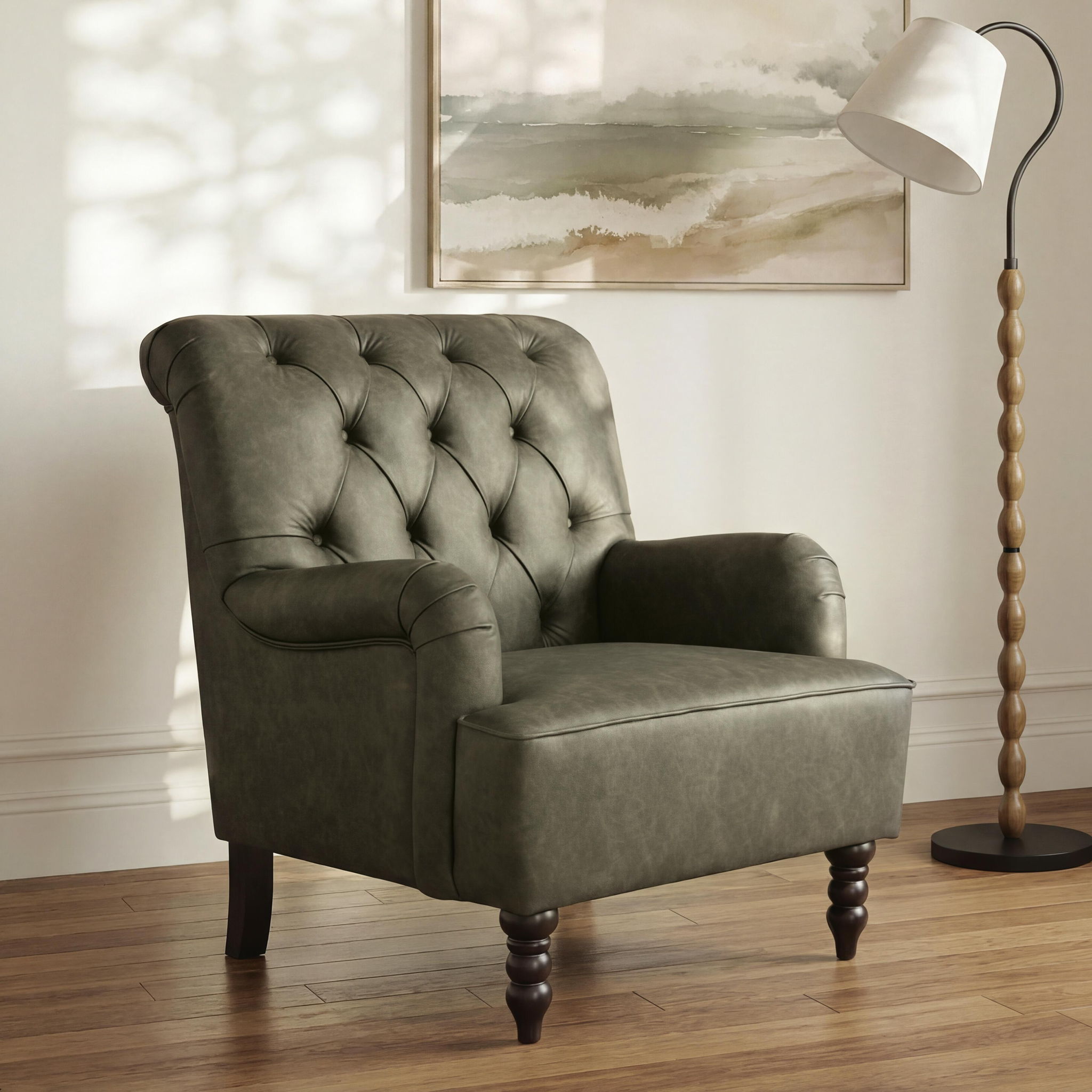 Green upholstered accent chair with tufted back, padded arms, and dark wooden legs