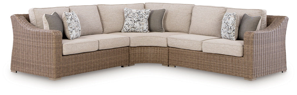 Beige outdoor sectional sofa with cushioned seats and two throw pillows