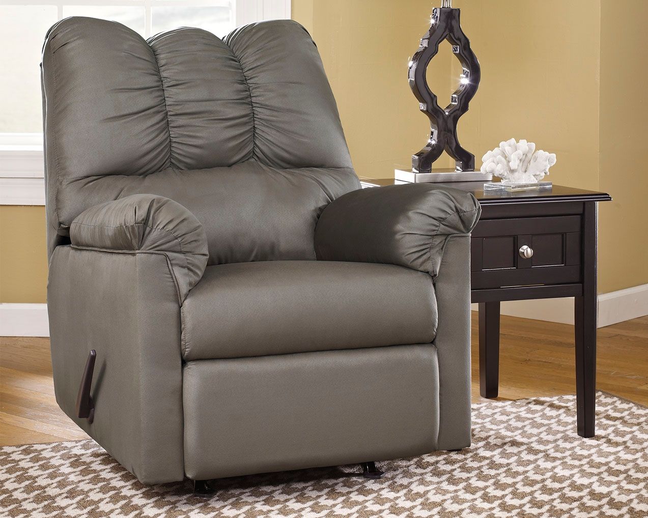 Gray rocker recliner with extended footrest and tufted back cushions