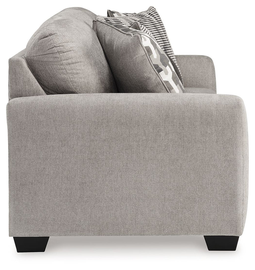 Gray upholstered chair with two throw pillows