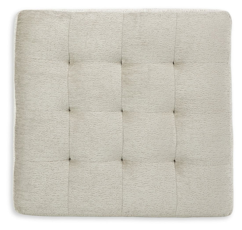 Beige upholstered ottoman top with stitched, square tufted pattern