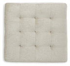 Beige upholstered ottoman top with stitched, square tufted pattern