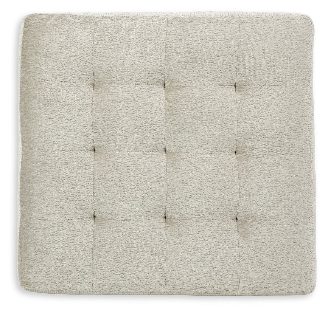 Beige upholstered ottoman top with stitched, square tufted pattern