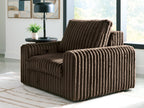 Chocolate corduroy power gliding chaise with curved arms and tall backrest.