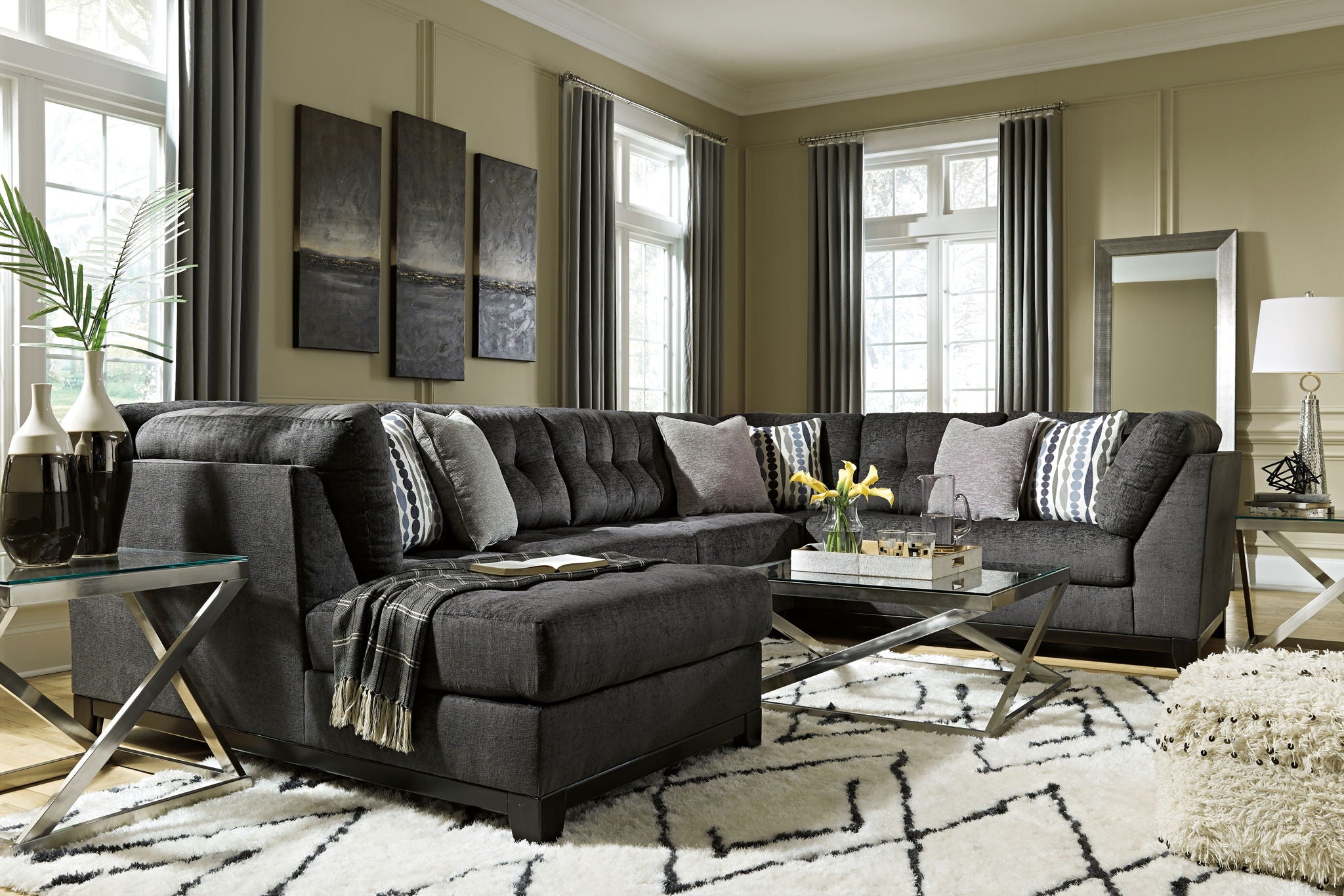 Gray sectional sofa with corner chaise and multiple patterned pillows