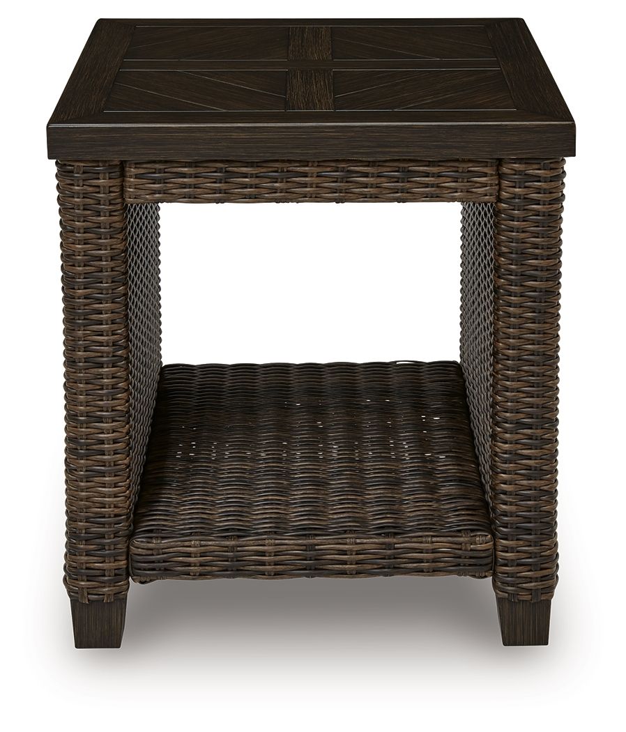 Rectangular woven patio table with dark brown tabletop and open storage shelf