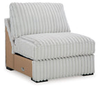 Light gray armless upholstered chair with vertical channel quilting and padded seat.
