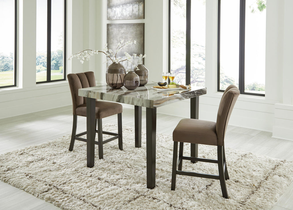 Counter-height dining table with dark brown upholstered stools and marble-look top