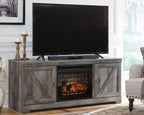 Gray media console with TV on top and glowing fireplace insert in center cabinet