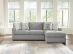 Dark gray sleeper sectional sofa with chaise seat and three geometric accent pillows