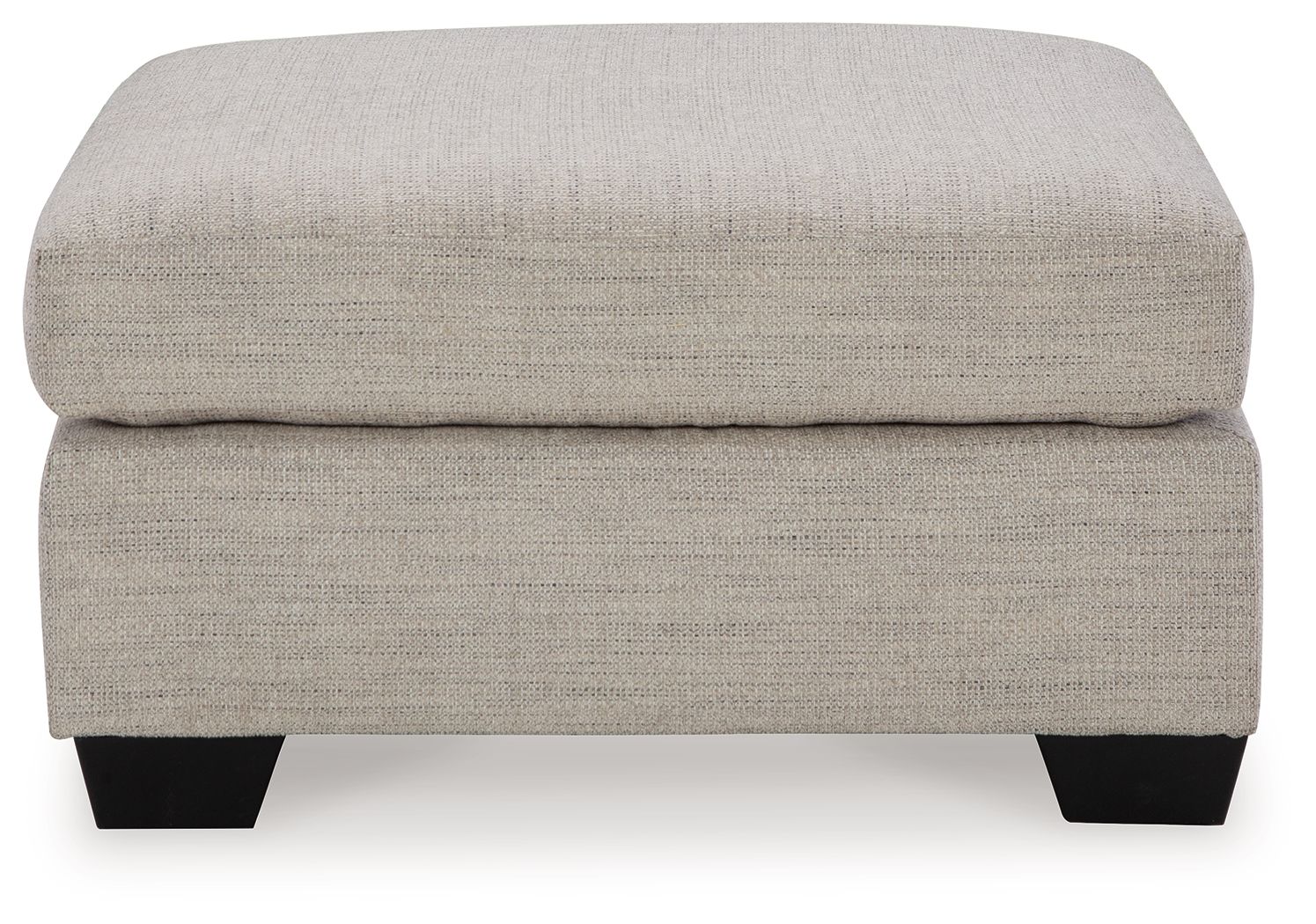 Oversized ottoman with light beige fabric, thick cushioned top and squared black legs.