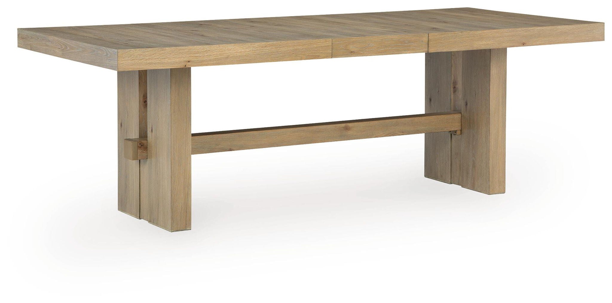 Light brown rectangular dining table with extension leaf seams and sturdy cross supports
