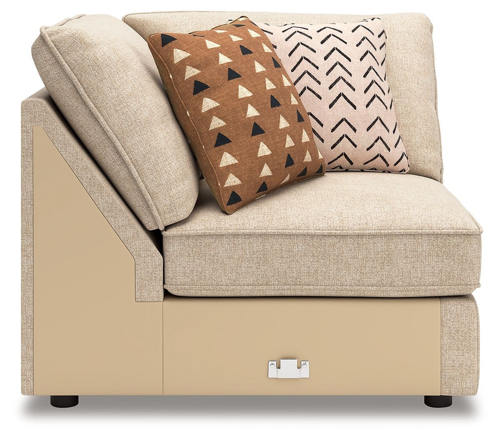 Beige fabric wedge chair with two patterned geometric throw pillows