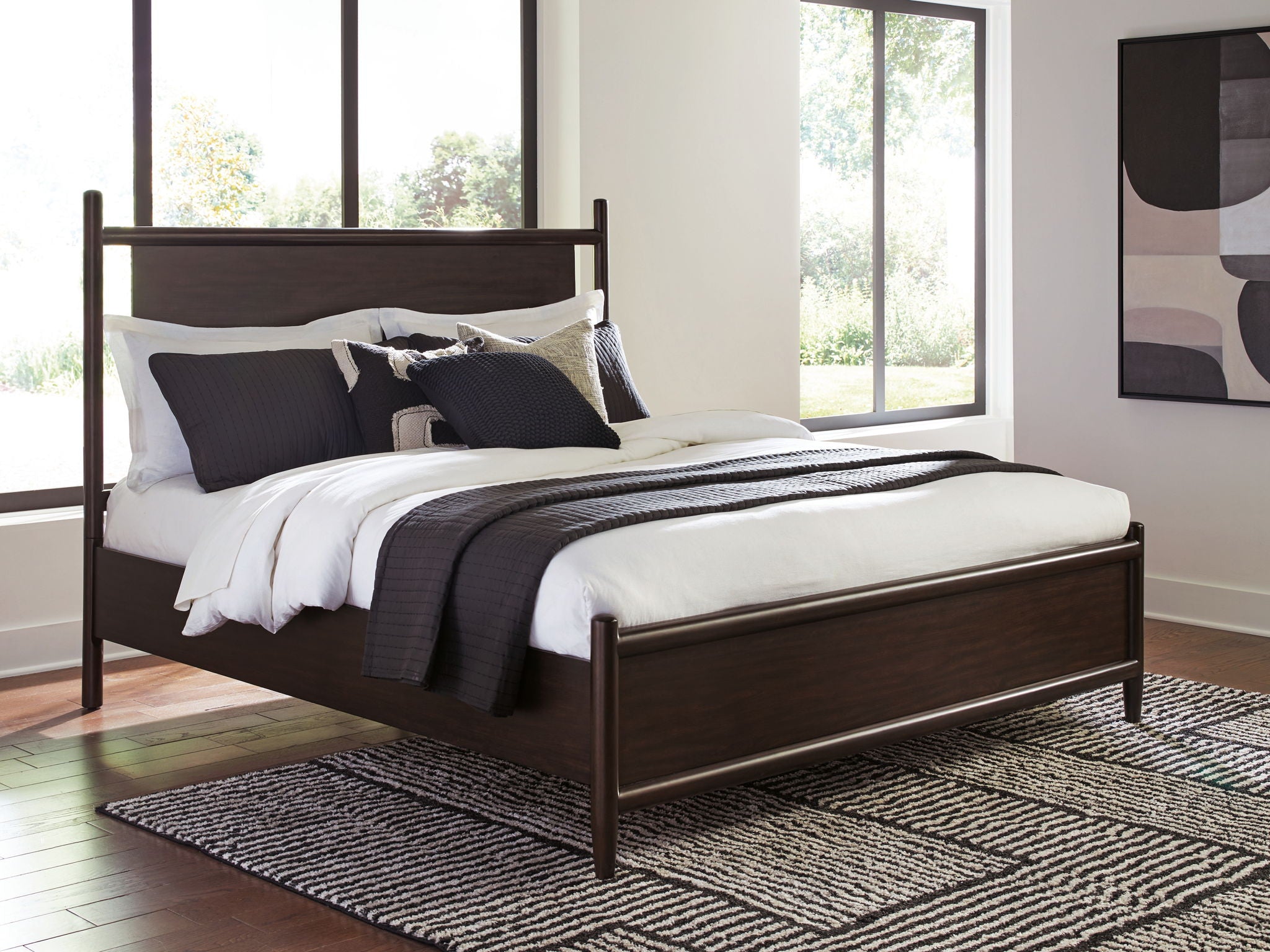 Dantenton panel bed in dark brown with pillows and white bedding