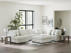 Off-white striped sectional sofa with chaise corner and multiple throw pillows.