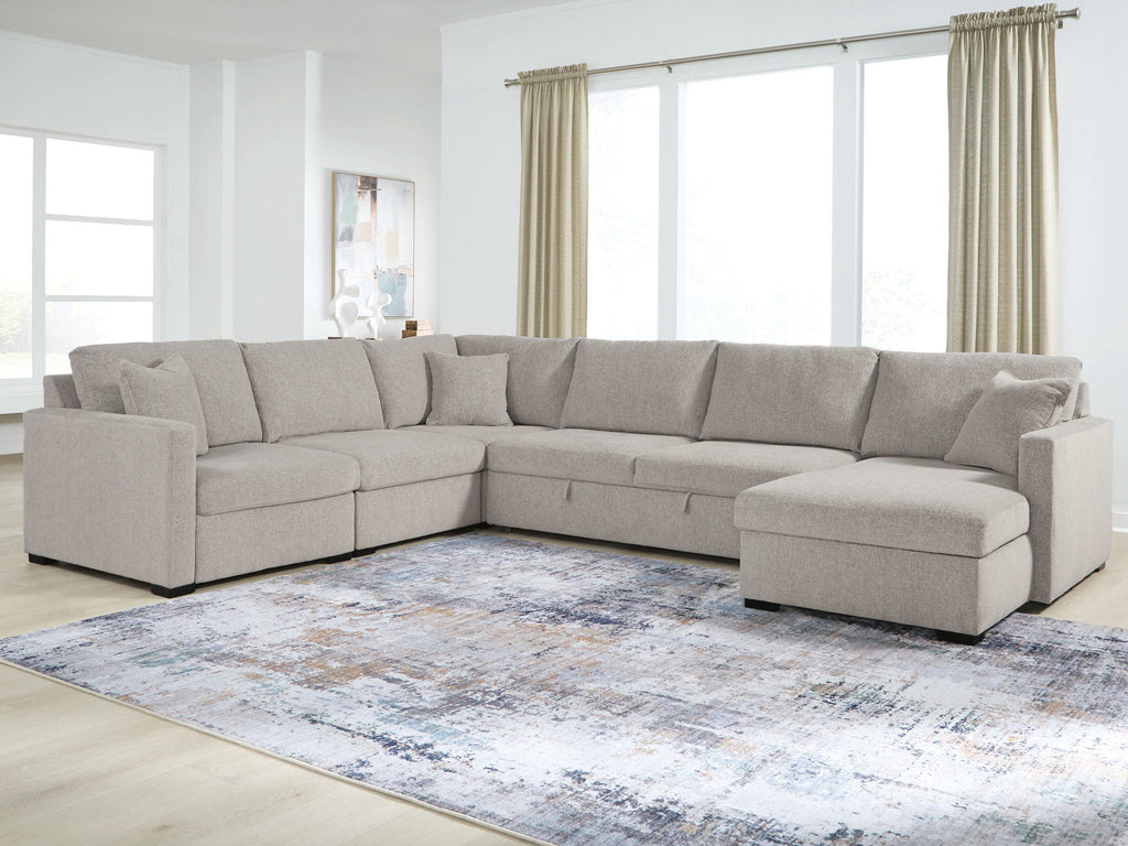 Gray sectional sofa with chaise seating, square arms, and contoured back cushions