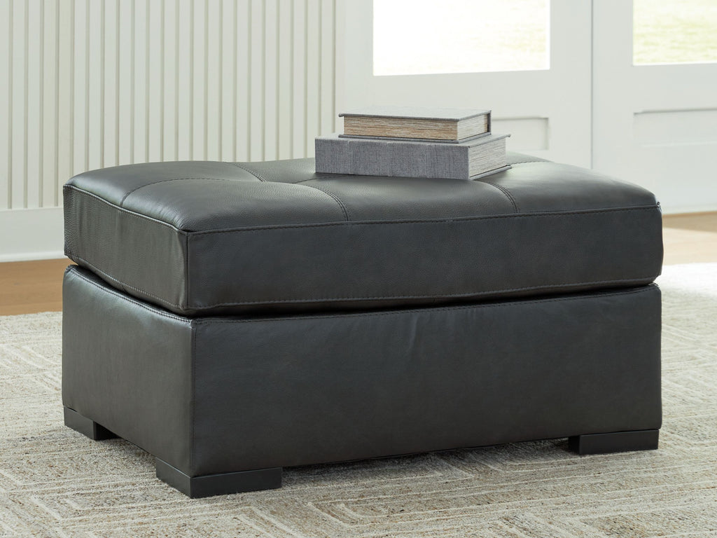 Oversized accent ottoman in dark gray with low profile and tufted seat top