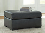 Oversized accent ottoman in dark gray with low profile and tufted seat top
