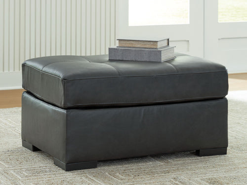 Oversized accent ottoman in dark gray with low profile and tufted seat top