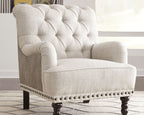Light gray upholstered accent chair with tufted back, rolled arms, and nailhead trim