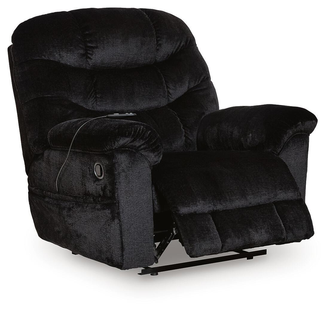 Black upholstered recliner chair with headrest, button-tufted back, padded arms, and base
