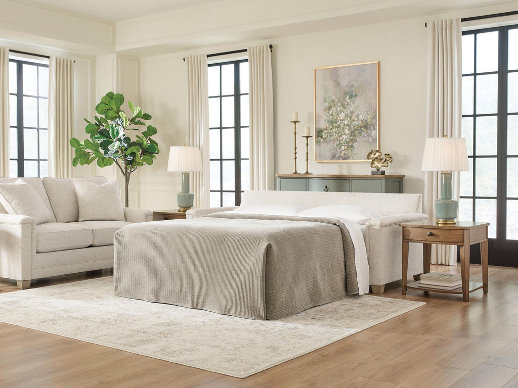 Queen sofa sleeper with bed extended, light beige upholstery and three back cushions