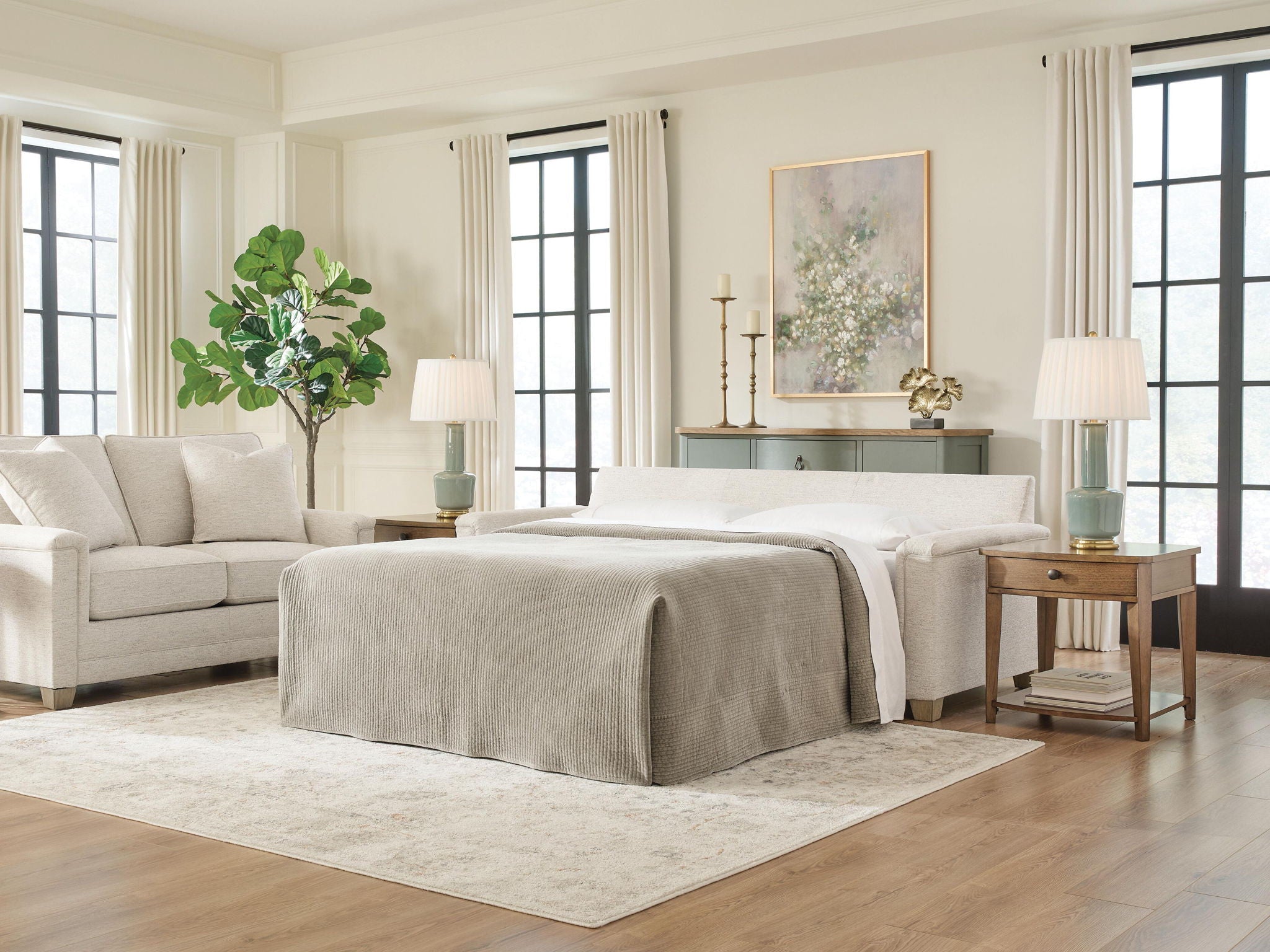 Queen sofa sleeper with bed extended, light beige upholstery and three back cushions