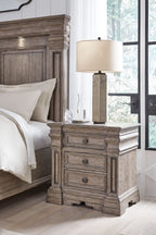 Three-drawer night stand with lamp on top, light grayish brown finish, round knobs