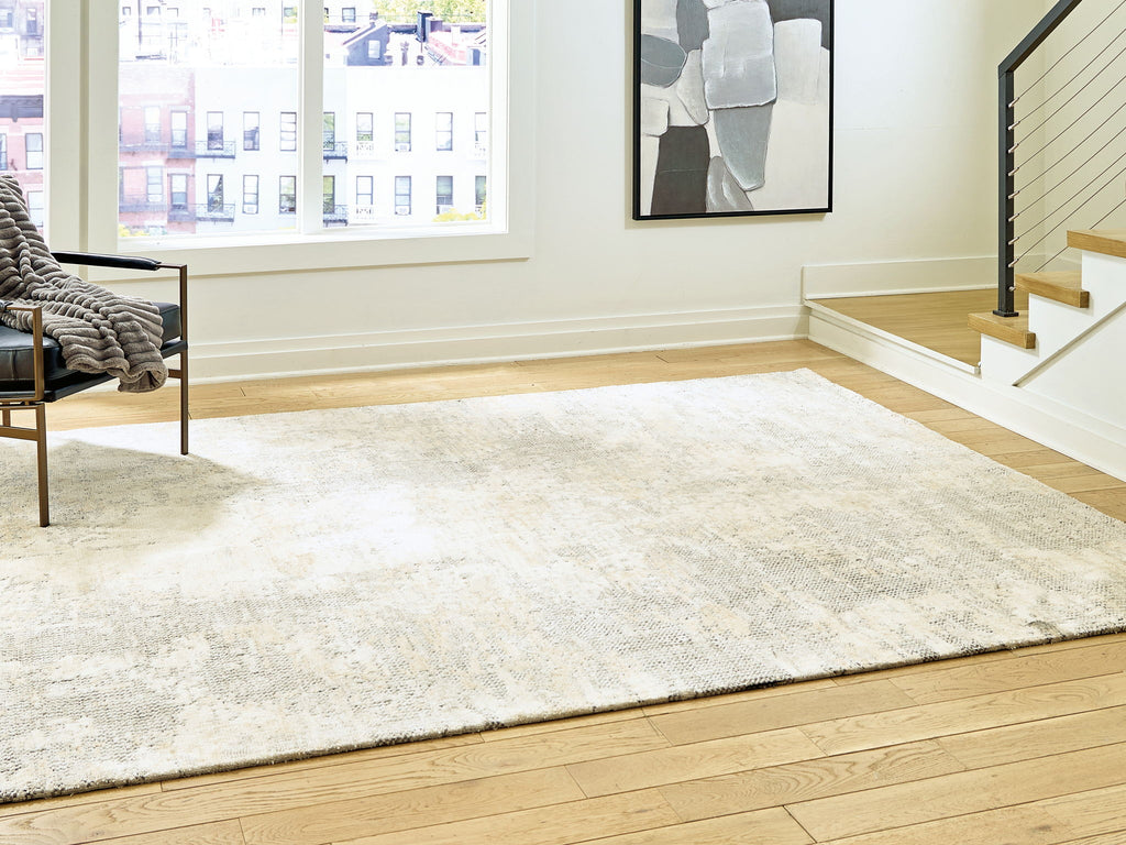 Cream area rug with mottled gray pattern and soft, low pile