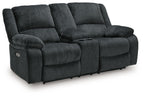 Dark gray reclining loveseat with rounded armrests and tall back cushions
