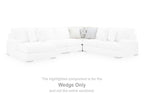 White sectional wedge with tufted seat cushions, low arms, and dark feet