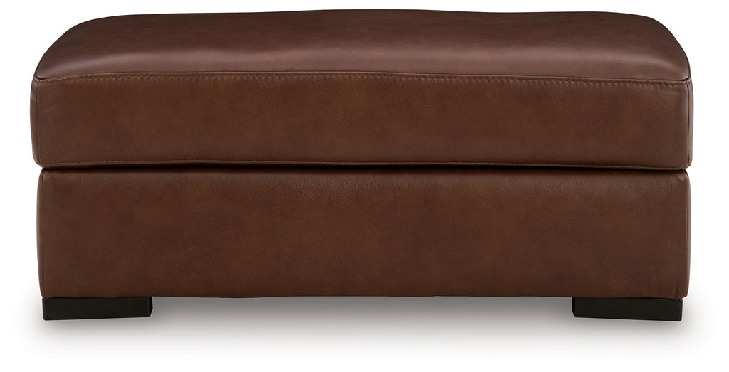 Brown leather rectangular ottoman with rounded top and visible side seams