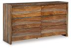 Light brown wood dresser with six drawer fronts and recessed panel design