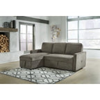 Charcoal sectional sofa bed with pop-up mattress, chaise and tufted cushions