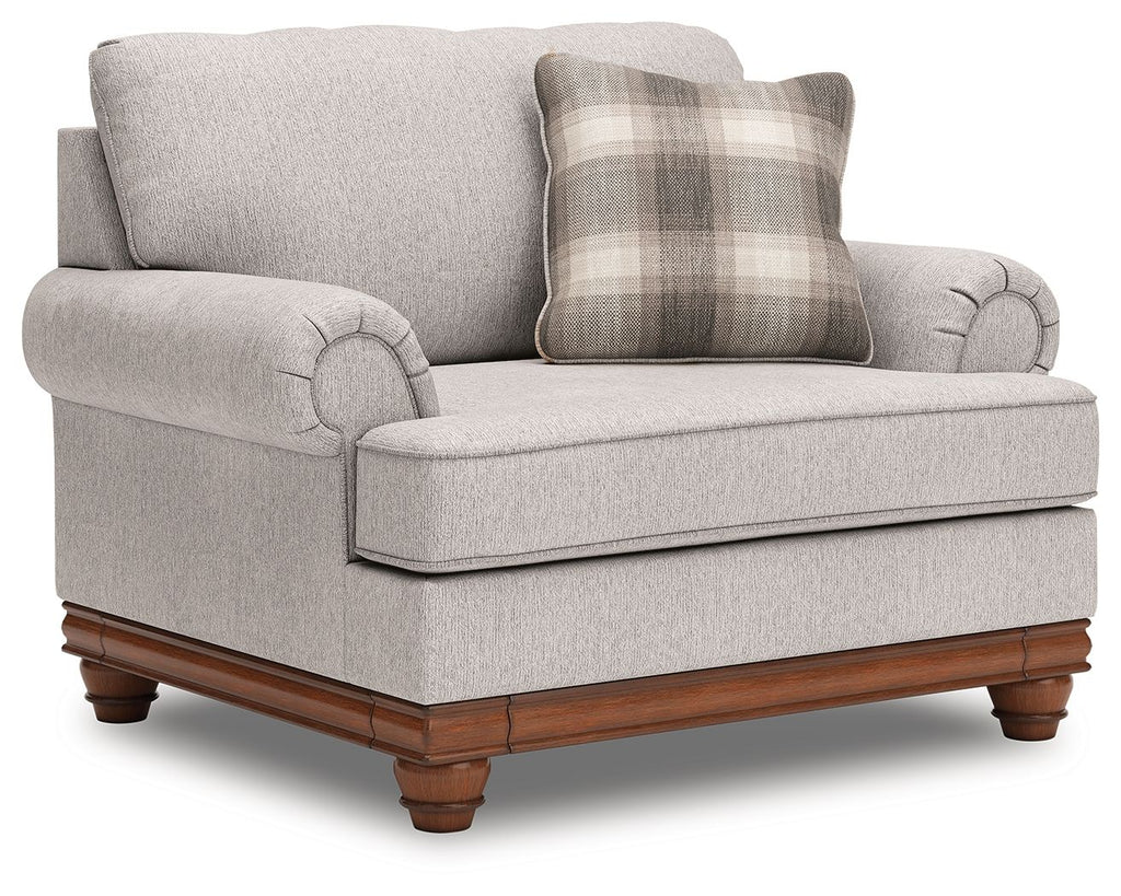 Light-gray chair and a half with plaid cushion, deep seat, and dark wood legs