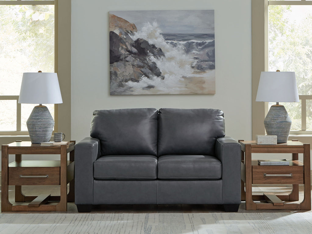 Gray loveseat sofa with two seat cushions, tufted back, and dark legs