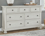 Antique white dresser with seven drawers and round knob pulls, spacious drawer fronts.