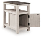 Chair side end table with open shelf and one-door cabinet, light wood finish, two black handles.