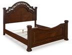 Dark brown poster bed with tall arched headboard, paneled footboard, turned legs