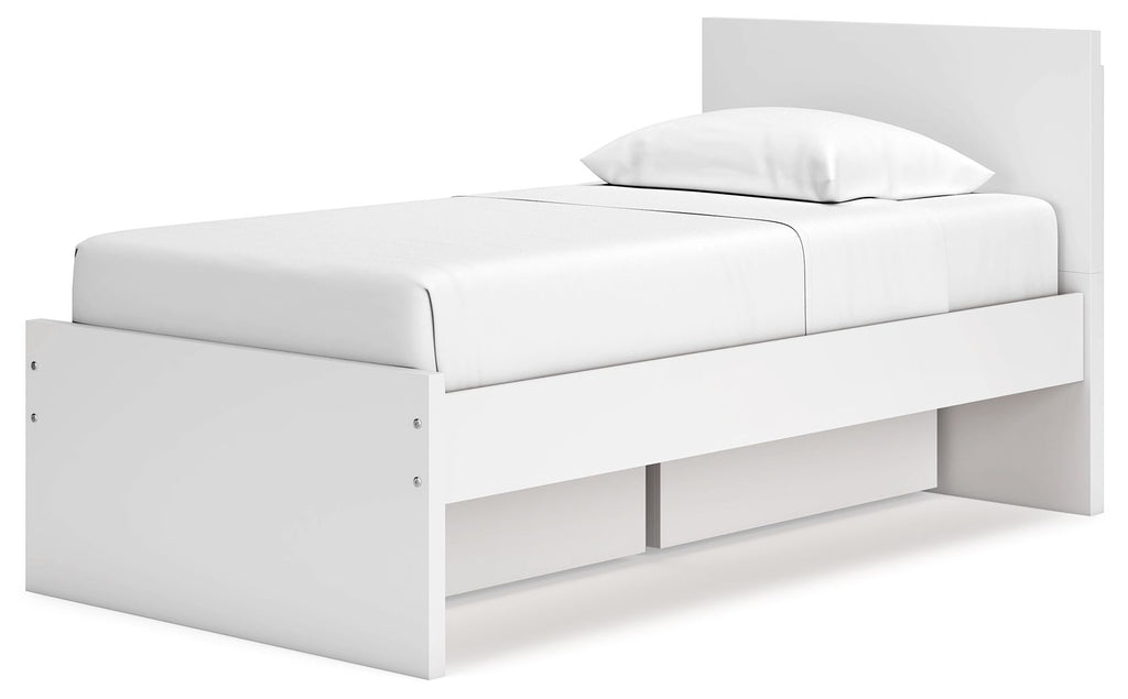 White panel platform bed with headboard and low-profile side storage drawers.