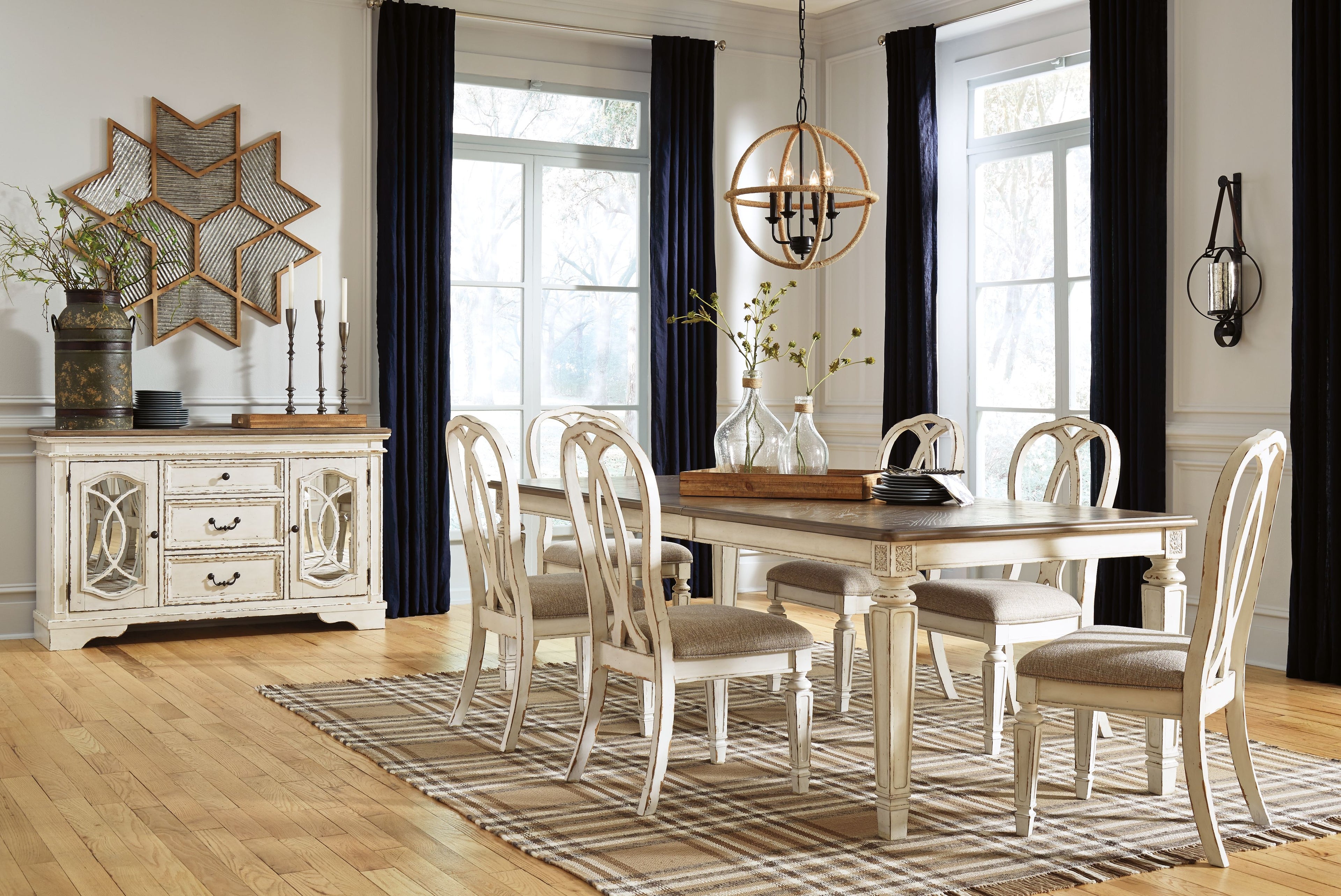 White rectangular dining table set with spindle-back chairs and decorative server