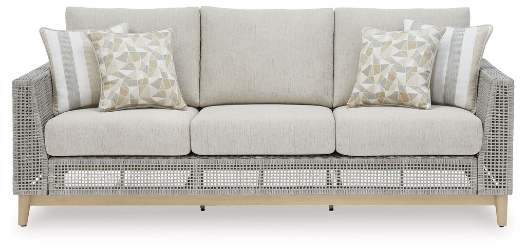 Gray woven sofa with cushions and matching striped back pillows