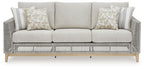 Gray woven sofa with cushions and matching striped back pillows