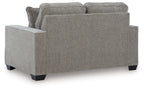 Gray upholstered loveseat with two back cushions and thick armrests